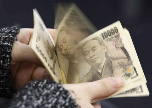 A Woman Counts Japanese 10,000 Yen Notes In Tokyo, In This Picture Illustration